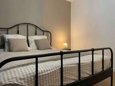 a bedroom with a black bed with white pillows at Appartement design pour 6 pers dans le centre de Salon de Pce - Proche Fontaine Moussue in Salon-de-Provence