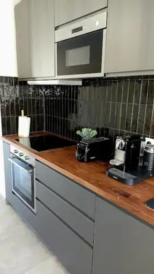 a kitchen with a counter with a sink and a microwave at Appartement design pour 6 pers dans le centre de Salon de Pce - Proche Fontaine Moussue in Salon-de-Provence