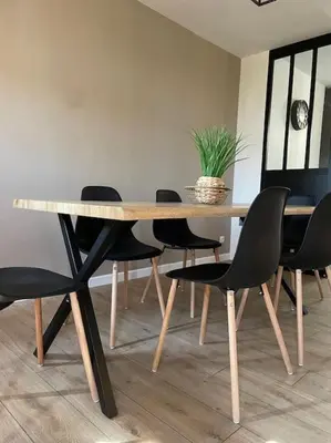 a dining room table with black chairs and a potted plant at Appartement design pour 6 pers dans le centre de Salon de Pce - Proche Fontaine Moussue in Salon-de-Provence