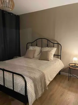 a bedroom with a bed with white sheets and pillows at Appartement design pour 6 pers dans le centre de Salon de Pce - Proche Fontaine Moussue in Salon-de-Provence