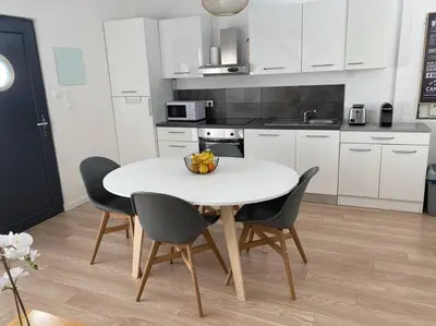 a kitchen with a white table and chairs in a room at 