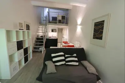 a living room with a couch and a living room with aearcher at Le Gassendi Duplex in Aix-en-Provence