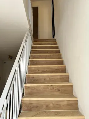 a staircase with wooden steps in a house at La Collégiale in LʼIsle-sur-la-Sorgue