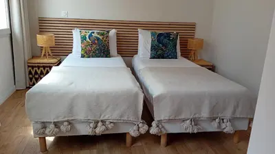 two beds sitting next to each other in a room at La Collégiale in LʼIsle-sur-la-Sorgue