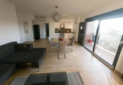 a living room with a black couch and a table at 
