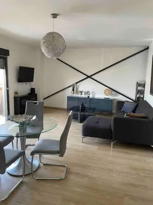 a living room with a couch and a glass table at 