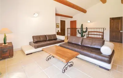 a living room with a leather couch and a table at Cozy Home In Apt With Wifi in Apt