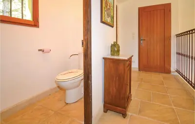 a bathroom with a toilet and a wooden door at Cozy Home In Apt With Wifi in Apt
