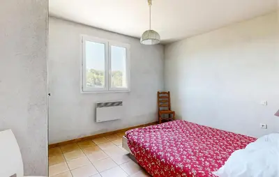 a bedroom with a red bed and a window at 3 Bedroom Stunning Home In Bédoin in Bédoin