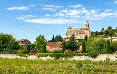 a large building in the middle of a garden at 3 Bedroom Stunning Home In Bédoin in Bédoin