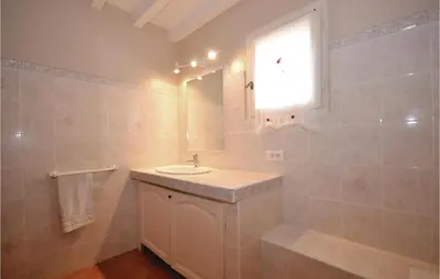 a bathroom with a sink and a mirror at Amazing Home In St Martin De Castillon in Saint-Martin-de-Castillon