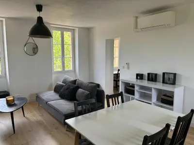 a living room with a couch and a table at Havre de paix au sein d'un T3 d'une bastide aixoise in Aix-en-Provence