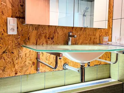 a bathroom sink with a glass counter top at L'Escargolette - Incroyable maison de vacances 4 étoiles in Carpentras