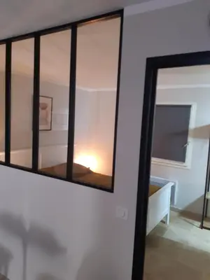 a mirror on a wall next to a room at Le gîte d'églantine in Eyguières