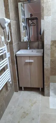 a bathroom with a sink and a mirror at Le gîte d'églantine in Eyguières