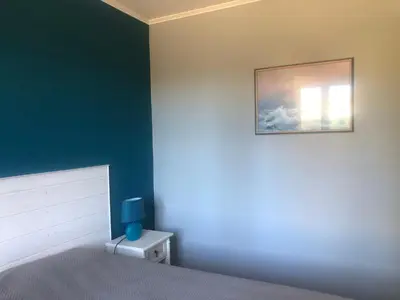 a bedroom with a bed and a painting on the wall at VILLA AVEC PISCINE in Roussillon