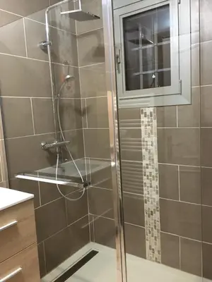 a shower with a glass door in a bathroom at VILLA AVEC PISCINE in Roussillon