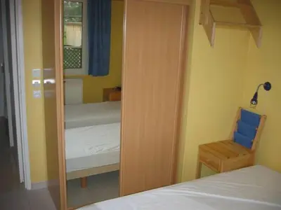 a bedroom with a mirror and a bed and a chair at Provence Vaucluse Ventoux Villa Caromb in Caromb