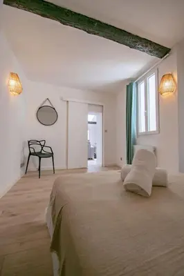 a white bedroom with a large bed and a window at Moderne et lumineux - clim - wifi in Aix-en-Provence