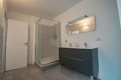 a bathroom with a shower and a sink and a mirror at Moderne et lumineux - clim - wifi in Aix-en-Provence