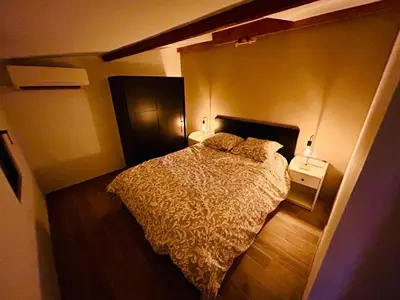 a bedroom with a bed in a small room at Ô Sorgue in LʼIsle-sur-la-Sorgue