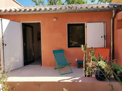 a blue chair sitting on the porch of a house at Luberon : maison près de Joucas et Gordes in Joucas