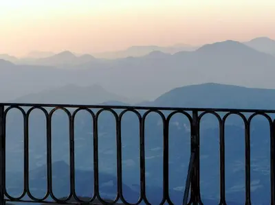 a fence with mountains in the background at Au Bregnat Vue du mont Ventoux in Bédoin