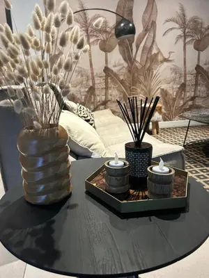a table with a glass vase and candles on it at Superbe maison avec jacuzzi in Ventabren