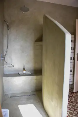 a bathroom with a shower in the corner of a room at Mas Gardane in Pernes-les-Fontaines