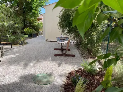 a bench sitting in the middle of a garden at Joli gite en Provence avec piscine in Aubignan