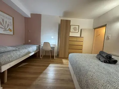 a bedroom with two beds and a desk and a chair at Les Bouteilles - 1 chambre hyper centre - 6p - Wifi in Aix-en-Provence