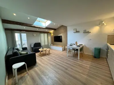 a living room with a couch and a table at Les Bouteilles - 1 chambre hyper centre - 6p - Wifi in Aix-en-Provence