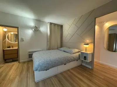 a bedroom with a bed and a mirror and a sink at Les Bouteilles - 1 chambre hyper centre - 6p - Wifi in Aix-en-Provence