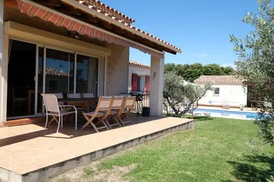 a patio with chairs and a table on a house at pretty detached villa with private swimming pool, in Aureille, in the alpilles - 8 people in Aureille