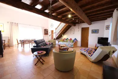 a living room with a couch and a table at pretty detached villa with private swimming pool, in Aureille, in the alpilles - 8 people in Aureille