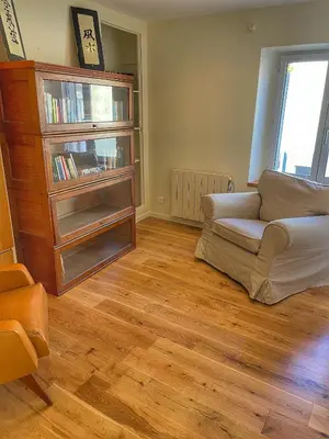 a living room with a couch and a book shelf at Le Petit Delphia in Apt