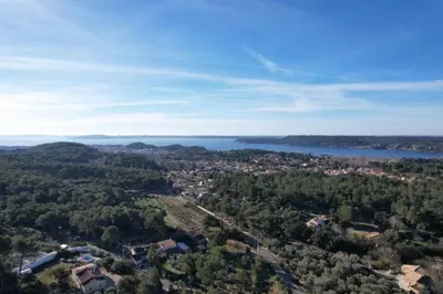 an aerial view of a city and a lake at Slpendid villa with heated pool and Jacuzzi for 12 people in Saint-chamas in Saint-Chamas