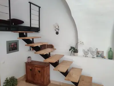 a room with wooden steps and shelves on the wall at Charme et authenticité dans une ferme. in Lourmarin