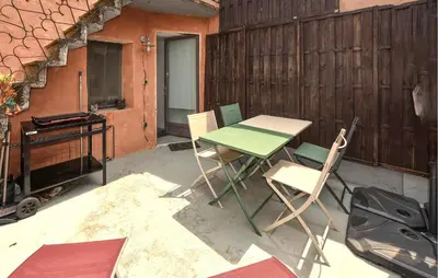 a table and chairs sitting on a patio at Beautiful Home In L'isle-Sur-La-Sorgue in LʼIsle-sur-la-Sorgue