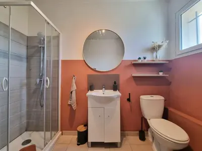 a bathroom with a toilet and a sink and a mirror at Joli studio lumineux centre avec parking securise dans quartier recherche in Aix-en-Provence