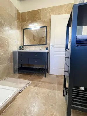 a bathroom with a sink and a mirror at Maison l’Oustaou Cornillonnais in Cornillon-Confoux