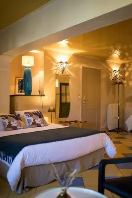 a bedroom with a large bed in a room at In Provence Hôtel - Expérience Authentique in Venelles