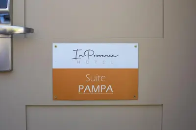 a sign for a hotel suite pampanga on a wall at In Provence Hôtel - Expérience Authentique in Venelles