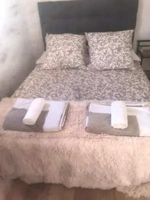 a bed with two towels and two pillows on it at la chambrette in Lincel
