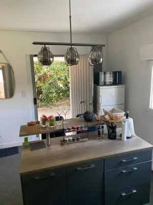 a kitchen with a wooden counter top in a room at SPA jardin privé T3 indépendant dans Villa in Morières-lès-Avignon