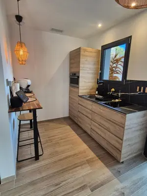 a kitchen with a sink and a counter at Le Cocoon - Jacuzzi, Sauna et Piscine privée in Carpentras