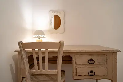 a wooden desk with a chair and a lamp at Ô Coeur Des Ocres in Roussillon
