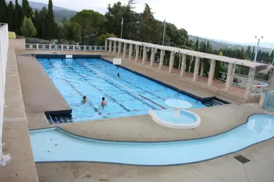 a large swimming pool with two people in it at Location au cœur du Luberon 2 personnes in Saint-Saturnin-les-Apt