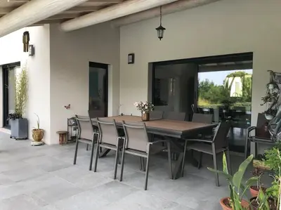 a dining room with a wooden table and chairs at Magnifique villa avec piscine Mt Ventoux Provence in Carpentras