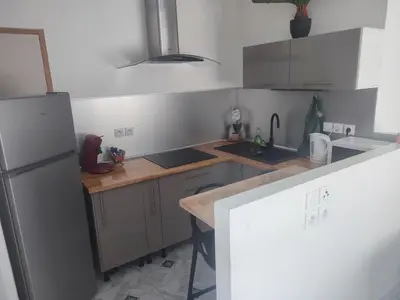 a kitchen with a refrigerator and a counter top at Studio Zen Miramas in Miramas